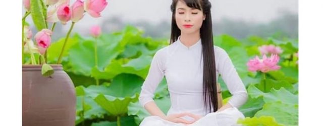 The full lotus position is a good for achieving trance in meditation, and according to traditional Chinese medicine, helps revitalize the body. Here, a woman demonstrates the sitting meditation in the spiritual practice of Falun Dafa.